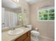 Bathroom with wooden vanity, decorative wallpaper, and natural light at 978 W Mill Bnd, Kennesaw, GA 30152