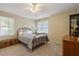 Cozy bedroom featuring neutral tones, carpet, and a wrought iron bed frame at 978 W Mill Bnd, Kennesaw, GA 30152
