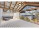 Inviting covered deck with hot tub, metal roof, and ceiling fan, providing a relaxing outdoor space at 978 W Mill Bnd, Kennesaw, GA 30152