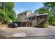 Two-story home featuring an outdoor garage, deck, and sunroom, with a spacious driveway at 978 W Mill Bnd, Kennesaw, GA 30152