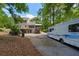 Rear view of home featuring garage, deck, and recreational vehicle parking at 978 W Mill Bnd, Kennesaw, GA 30152