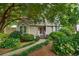 Quaint home featuring a lovely garden, a well-manicured lawn, and a welcoming front porch at 978 W Mill Bnd, Kennesaw, GA 30152
