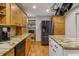Spacious kitchen with granite countertops, stainless appliances, and hardwood floors at 978 W Mill Bnd, Kennesaw, GA 30152
