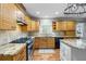 Bright kitchen showcases custom cabinets, granite counters, stainless steel appliances, and wood floors at 978 W Mill Bnd, Kennesaw, GA 30152