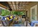 Relaxing covered patio with comfortable seating and view of the wooded backyard at 978 W Mill Bnd, Kennesaw, GA 30152