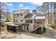 Rear view of the home featuring a deck, screened in porch, hot tub and a spacious driveway at 978 W Mill Bnd, Kennesaw, GA 30152