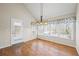 Bright sunroom with hardwood floors, a vaulted ceiling, multiple windows, and a door leading to an outdoor deck at 978 W Mill Bnd, Kennesaw, GA 30152