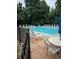 Community swimming pool surrounded by lounge chairs and trees for shade at 978 W Mill Bnd, Kennesaw, GA 30152