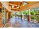 Covered porch with brick columns, ceiling fans, and slate flooring at 3700 Tom Brewer Rd, Loganville, GA 30052