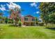 Backyard with lush lawn features a two-story home with patio area and a chain-link fence at 3700 Tom Brewer Rd, Loganville, GA 30052