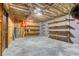 Unfinished basement featuring concrete floor and wood shelving for ample storage space at 3700 Tom Brewer Rd, Loganville, GA 30052