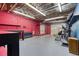 Finished basement features workout equipment, a mirror, and vibrant red walls at 3700 Tom Brewer Rd, Loganville, GA 30052