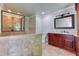 Bright bathroom featuring a large walk-in shower, granite vanity, and ceramic tile flooring at 3700 Tom Brewer Rd, Loganville, GA 30052