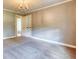 Bright bedroom with carpet flooring, neutral paint, and elegant lighting at 3700 Tom Brewer Rd, Loganville, GA 30052