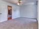 Bright bedroom with carpet flooring, neutral paint, and ceiling fan at 3700 Tom Brewer Rd, Loganville, GA 30052