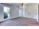 Bedroom featuring carpet flooring, large windows, and double door closet at 3700 Tom Brewer Rd, Loganville, GA 30052