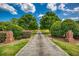 Long driveway lined with trees and manicured landscaping leading to a beautiful home at 3700 Tom Brewer Rd, Loganville, GA 30052