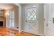 Well-lit entryway with a white diamond paneled door at 3700 Tom Brewer Rd, Loganville, GA 30052