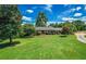 Charming brick home with manicured landscaping, a lush green lawn, and mature trees providing shade at 3700 Tom Brewer Rd, Loganville, GA 30052