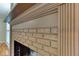 Close up of a tan brick fireplace with tan trim in a well-lit room at 3700 Tom Brewer Rd, Loganville, GA 30052