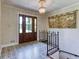 Elegant foyer with stylish floors, chandelier, and a wooden front door at 3700 Tom Brewer Rd, Loganville, GA 30052