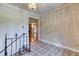 Entry foyer with elegant light fixture and decorative tiled floor at 3700 Tom Brewer Rd, Loganville, GA 30052