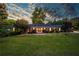 Beautiful brick home featuring a sprawling green lawn, mature trees, and a welcoming front entrance at 3700 Tom Brewer Rd, Loganville, GA 30052