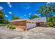 Spacious three-car garage with a covered patio, surrounded by well-maintained greenery at 3700 Tom Brewer Rd, Loganville, GA 30052