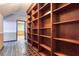 Hallway with tile floors and built-in wooden shelves at 3700 Tom Brewer Rd, Loganville, GA 30052