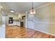 Open kitchen featuring stainless steel appliances, white cabinets, and view into dining area at 3700 Tom Brewer Rd, Loganville, GA 30052