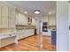 Bright kitchen features white cabinets, built-in appliances, and beautiful hardwood floors at 3700 Tom Brewer Rd, Loganville, GA 30052