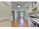 Bright kitchen with white cabinets and hardwood floors throughout at 3700 Tom Brewer Rd, Loganville, GA 30052