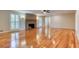 Spacious living room featuring hardwood floors and a brick fireplace at 3700 Tom Brewer Rd, Loganville, GA 30052