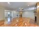 Bright living room featuring beautiful hardwood floors, ceiling fan, and fireplace at 3700 Tom Brewer Rd, Loganville, GA 30052