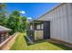 Backyard view of an enclosed kennel adjacent to the metal outbuilding at 3700 Tom Brewer Rd, Loganville, GA 30052