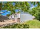 Exterior of outbuilding with metal siding, roll up doors, concrete driveway, and lawn at 3700 Tom Brewer Rd, Loganville, GA 30052