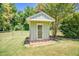 Backyard shed with a classic single entry door and surrounded by lawn and trees at 3700 Tom Brewer Rd, Loganville, GA 30052