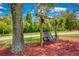 A tranquil backyard retreat with a charming porch swing surrounded by lush green grass and mulched ground at 3700 Tom Brewer Rd, Loganville, GA 30052