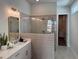 Bathroom featuring grey tiling, double vanity, and glass encased shower at 507 Godfrey Dr, Cumming, GA 30040