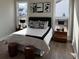 Bedroom with decoratively pillowed bed, wood nightstands, and contemporary art at 507 Godfrey Dr, Cumming, GA 30040