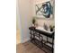 Modern hallway table featuring decorative art, greenery, and a set of glassware at 507 Godfrey Dr, Cumming, GA 30040