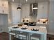 This kitchen offers a center island with barstool seating, stainless appliances, and white cabinets at 507 Godfrey Dr, Cumming, GA 30040