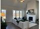 Cozy living room showcasing a fireplace, ample natural light, and stylish furnishings at 507 Godfrey Dr, Cumming, GA 30040