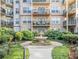 A courtyard garden features a stone fountain, manicured landscaping, and several apartment balconies at 230 E Ponce De Leon Ave # 322, Decatur, GA 30030