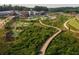 An aerial view of the community featuring a playground, amphitheater, and shopping district at 505 Godfrey Dr, Cumming, GA 30040