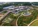 An aerial view of the community featuring a playground, amphitheater, and shopping district at 505 Godfrey Dr, Cumming, GA 30040