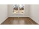 Bright bedroom featuring hardwood floors, white trim, and a view to the outside at 505 Godfrey Dr, Cumming, GA 30040