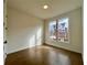 Well-lit bedroom featuring hardwood floors and a large window at 505 Godfrey Dr, Cumming, GA 30040