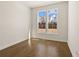 Bedroom with wood floors featuring large window with view of the neighborhood at 505 Godfrey Dr, Cumming, GA 30040