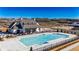 Overhead view of a stunning community pool surrounded by lush landscaping and a beautiful clubhouse at 505 Godfrey Dr, Cumming, GA 30040